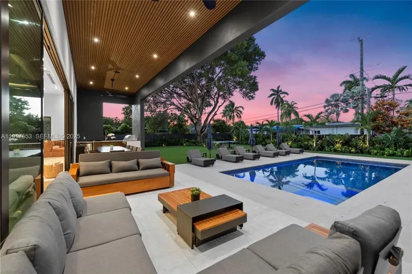 an aerial view of residential houses with outdoor space and swimming pool
