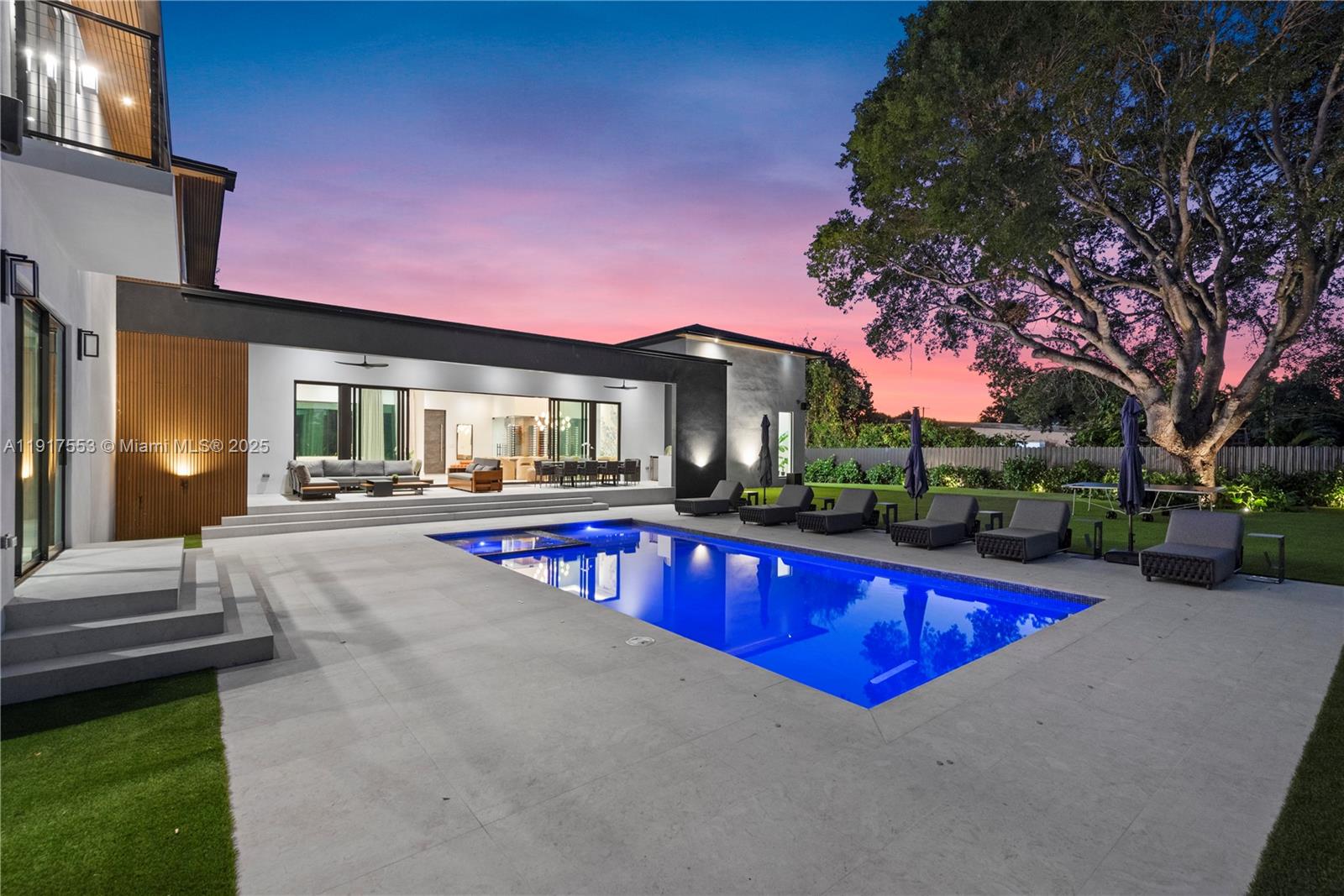1881 Northeast 196th Terrace Miami, FL 33179 - Photo 49 of 98 a view of swimming pool with outdoor seating and house in the background
