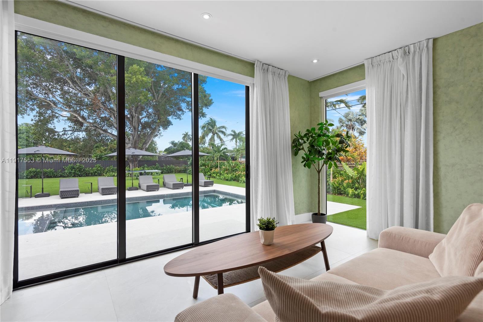 1881 Northeast 196th Terrace Miami, FL 33179 - Photo 60 of 98 a living room with furniture and a window