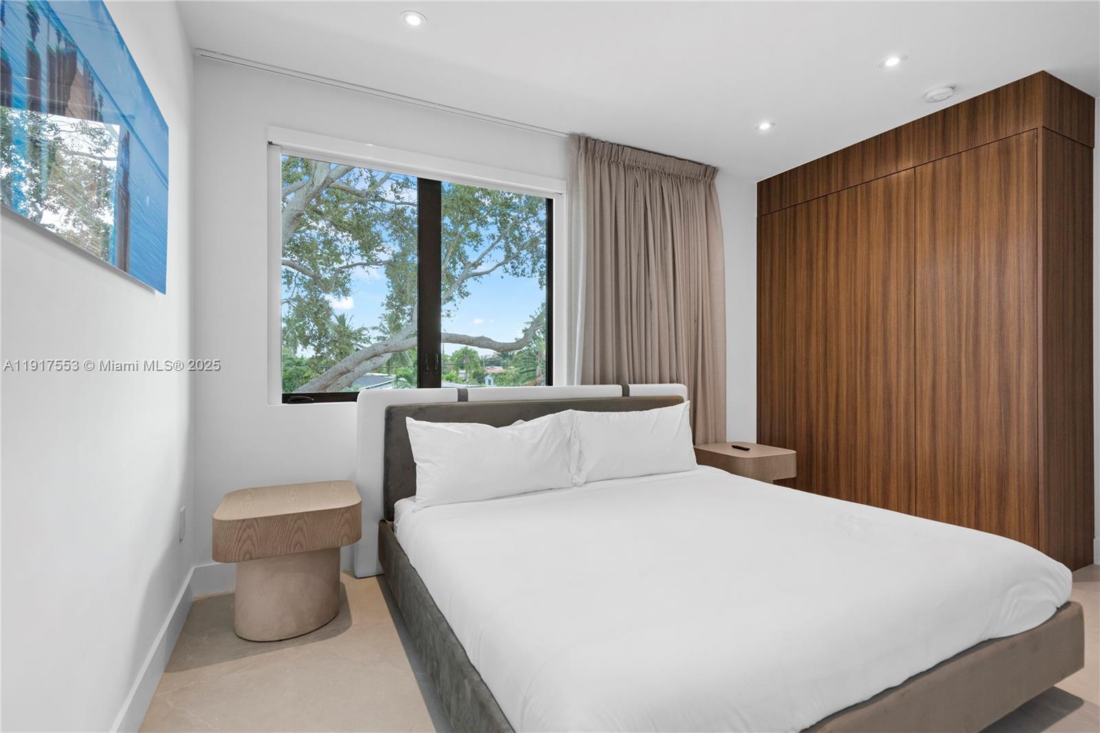 1881 Northeast 196th Terrace Miami, FL 33179 - Photo 75 of 98 a bedroom with a large bed and a large window