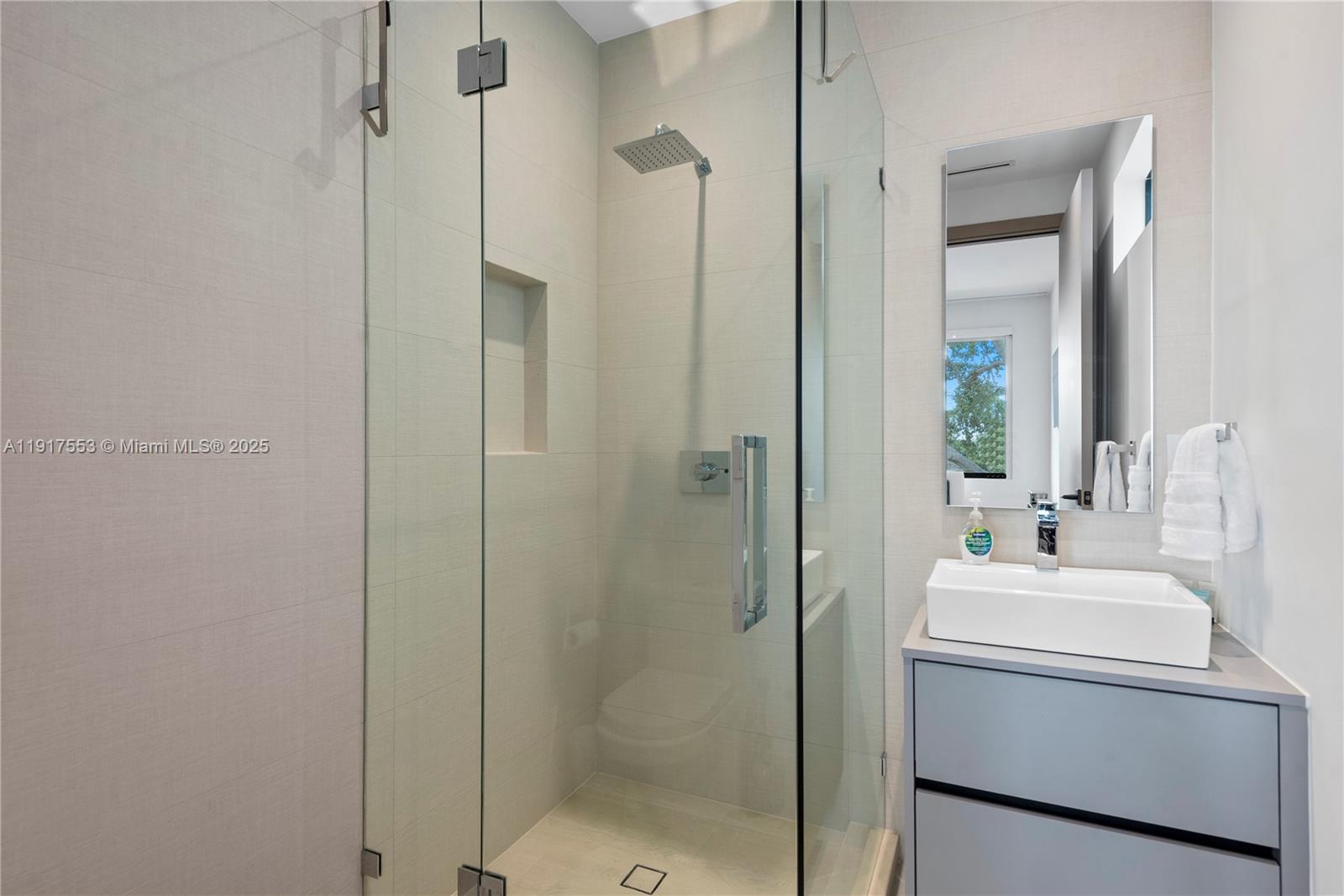 1881 Northeast 196th Terrace Miami, FL 33179 - Photo 76 of 98 a bathroom with a sink mirror and shower