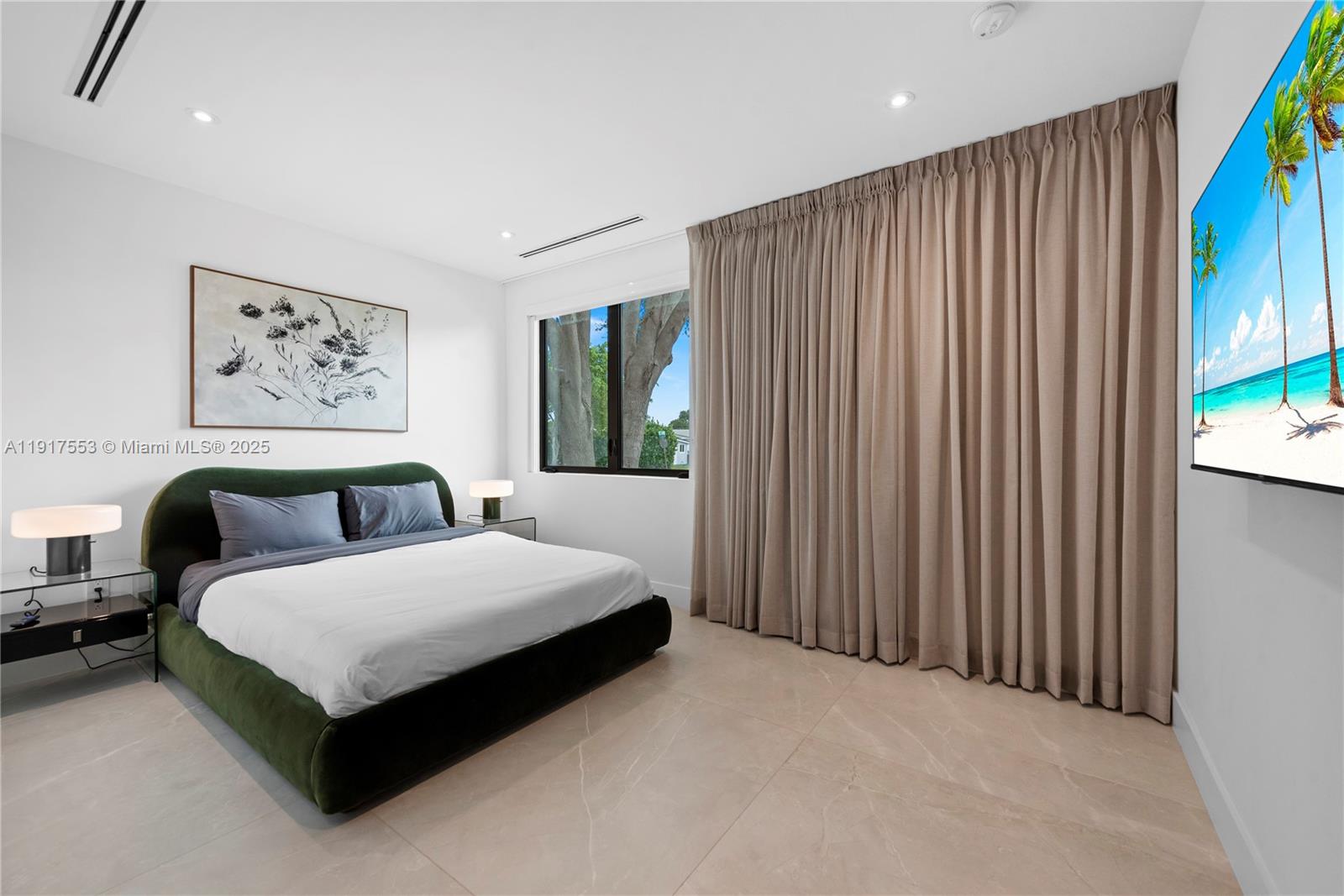 1881 Northeast 196th Terrace Miami, FL 33179 - Photo 78 of 98 a bedroom with a bed lamp and a large window