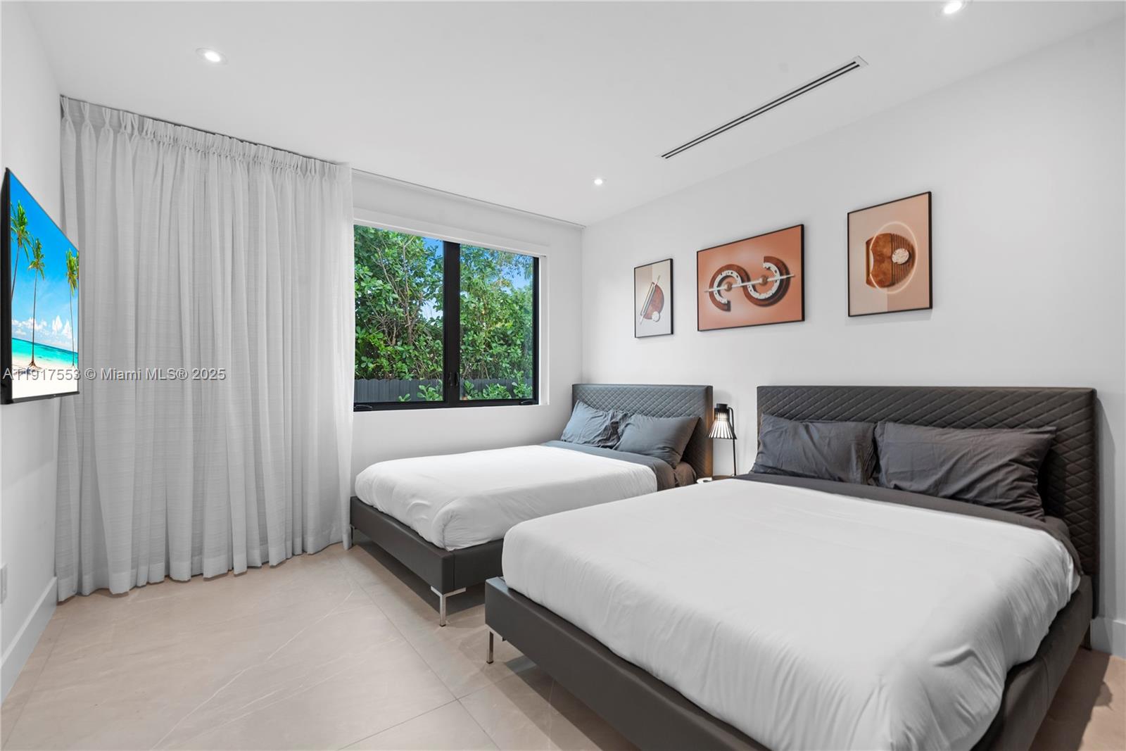 1881 Northeast 196th Terrace Miami, FL 33179 - Photo 81 of 98 a bedroom with two beds and a window