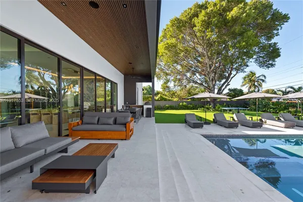 a living room with furniture garden view and a potted plant