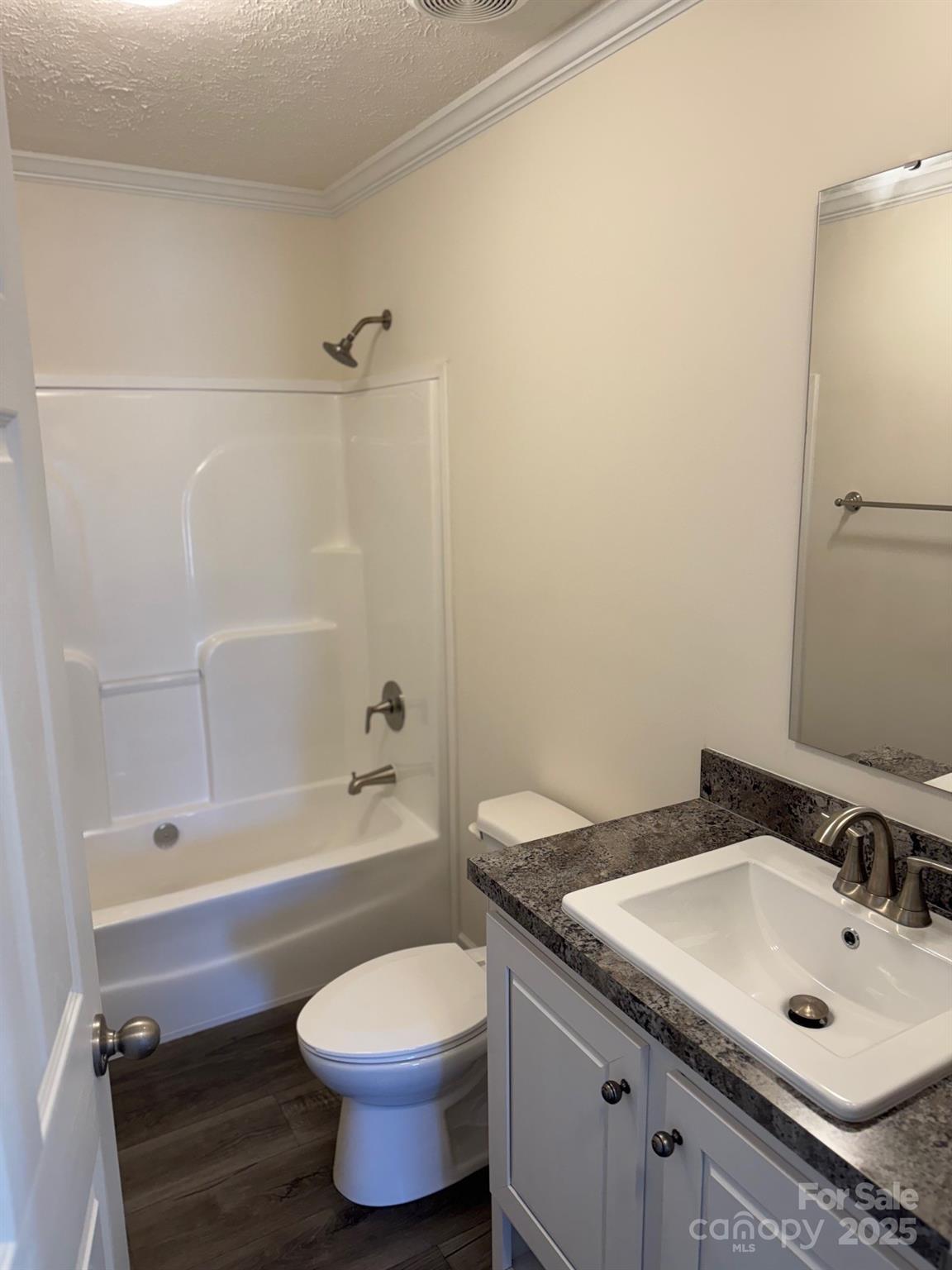 197 Burleson Point Woodleaf, NC 27054 - Photo 8 of 15 a bathroom with a granite countertop toilet a sink and a bathtub