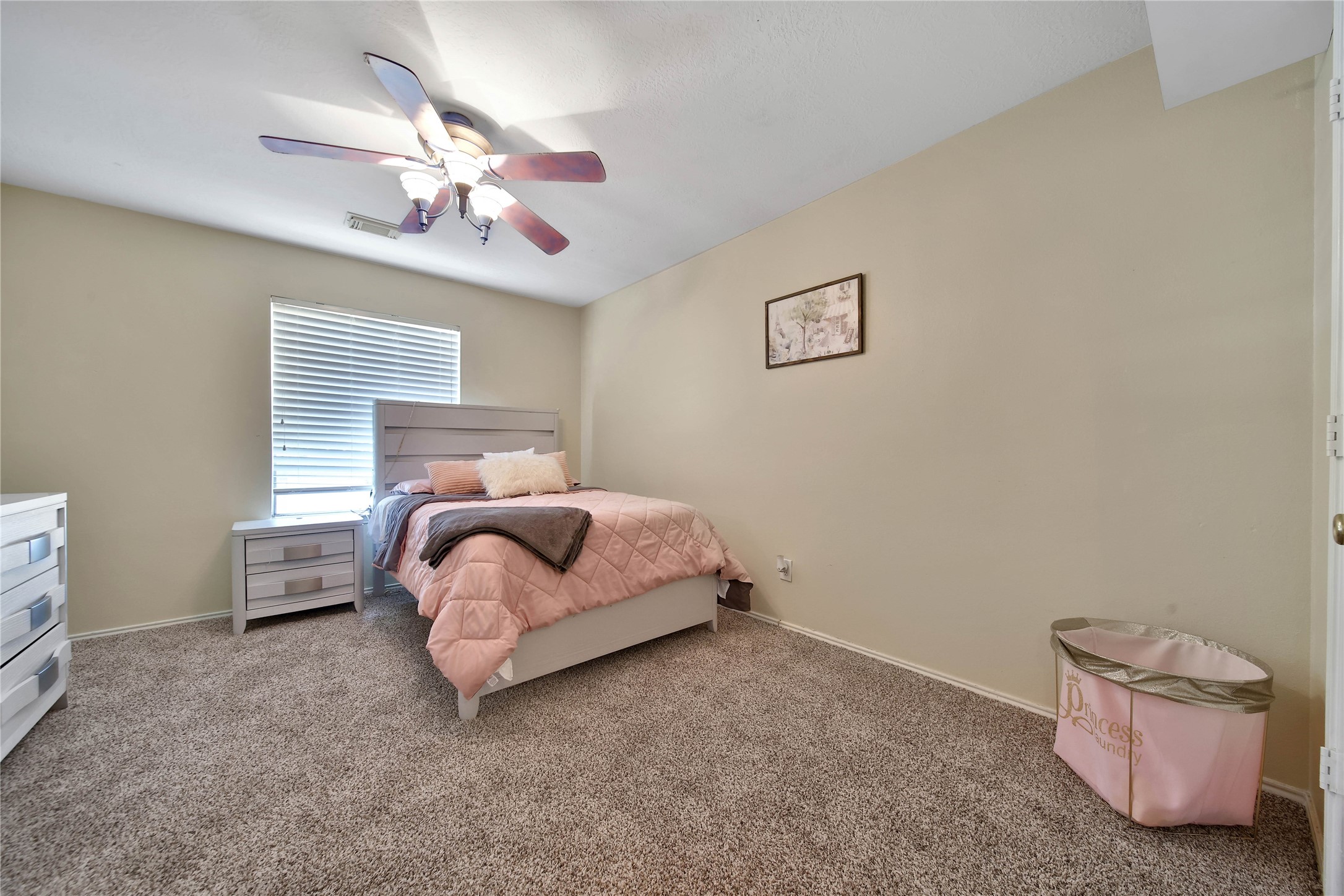 17323 Lobo Trail Houston, TX 77084 - Photo 14 of 21 a bedroom with a bed and a chandelier