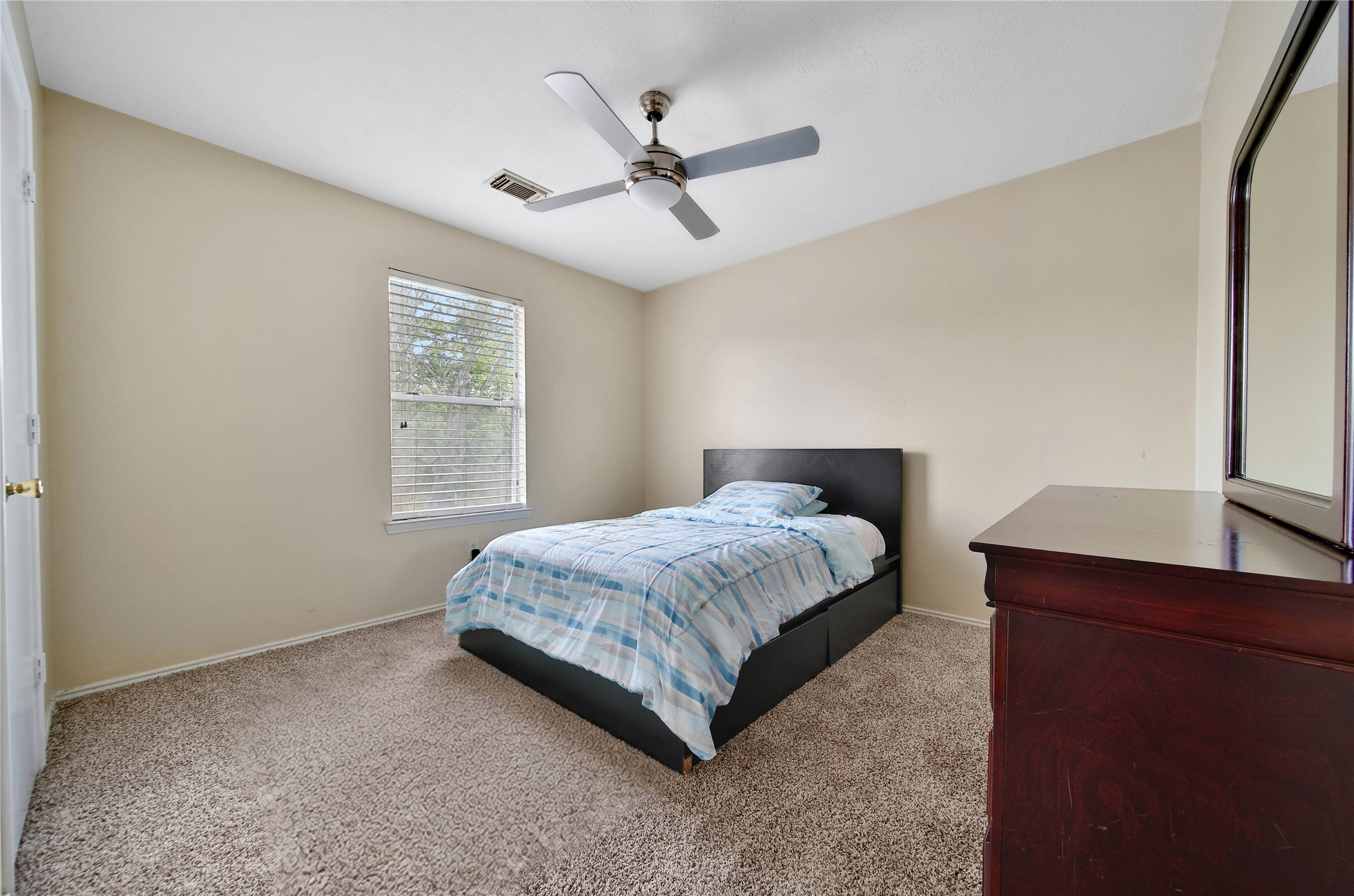 17323 Lobo Trail Houston, TX 77084 - Photo 15 of 21 a bedroom with a bed and window
