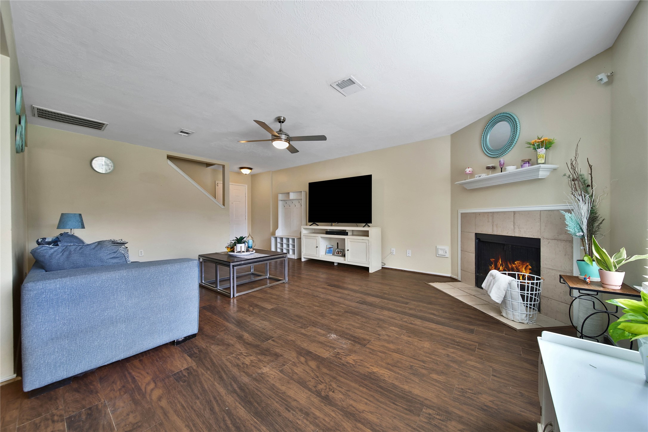 17323 Lobo Trail Houston, TX 77084 - Photo 5 of 21 a living room with furniture a flat screen tv and a fireplace