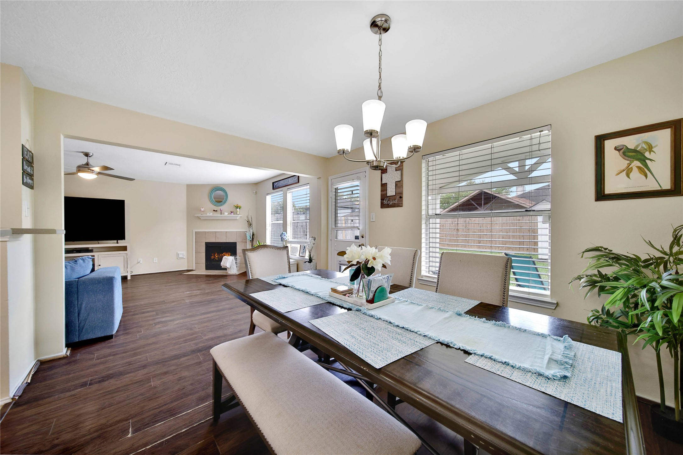 17323 Lobo Trail Houston, TX 77084 - Photo 8 of 21 a view of a dining room with furniture a chandelier and wooden floor