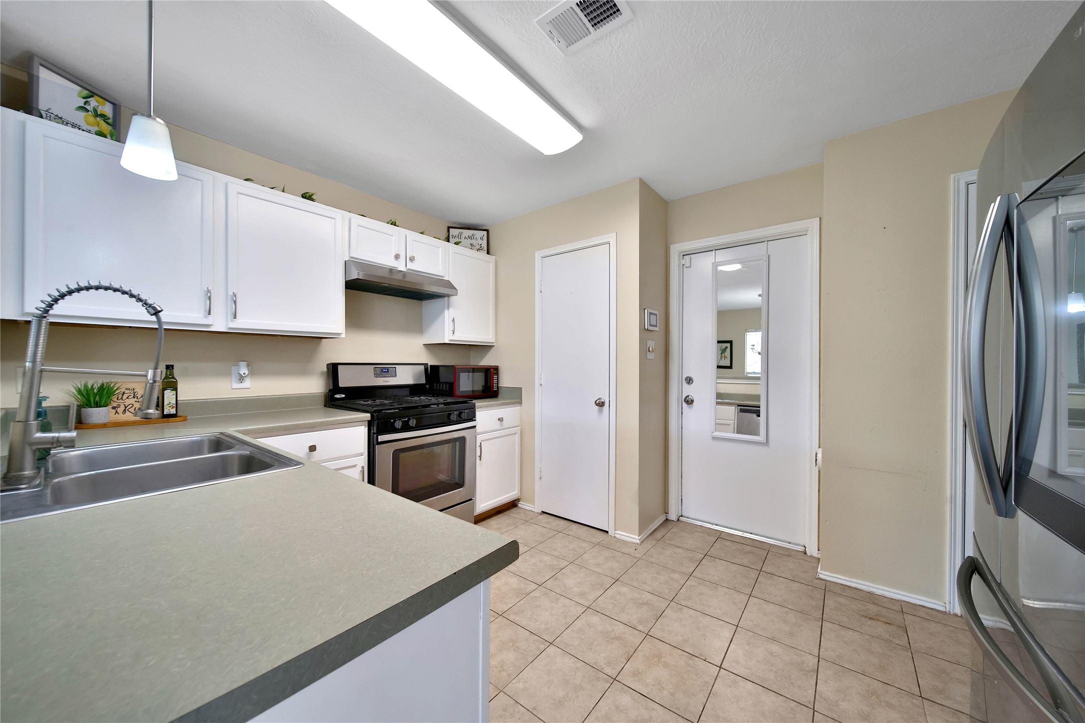 17323 Lobo Trail Houston, TX 77084 - Photo 9 of 21 a kitchen with a refrigerator and a stove top oven