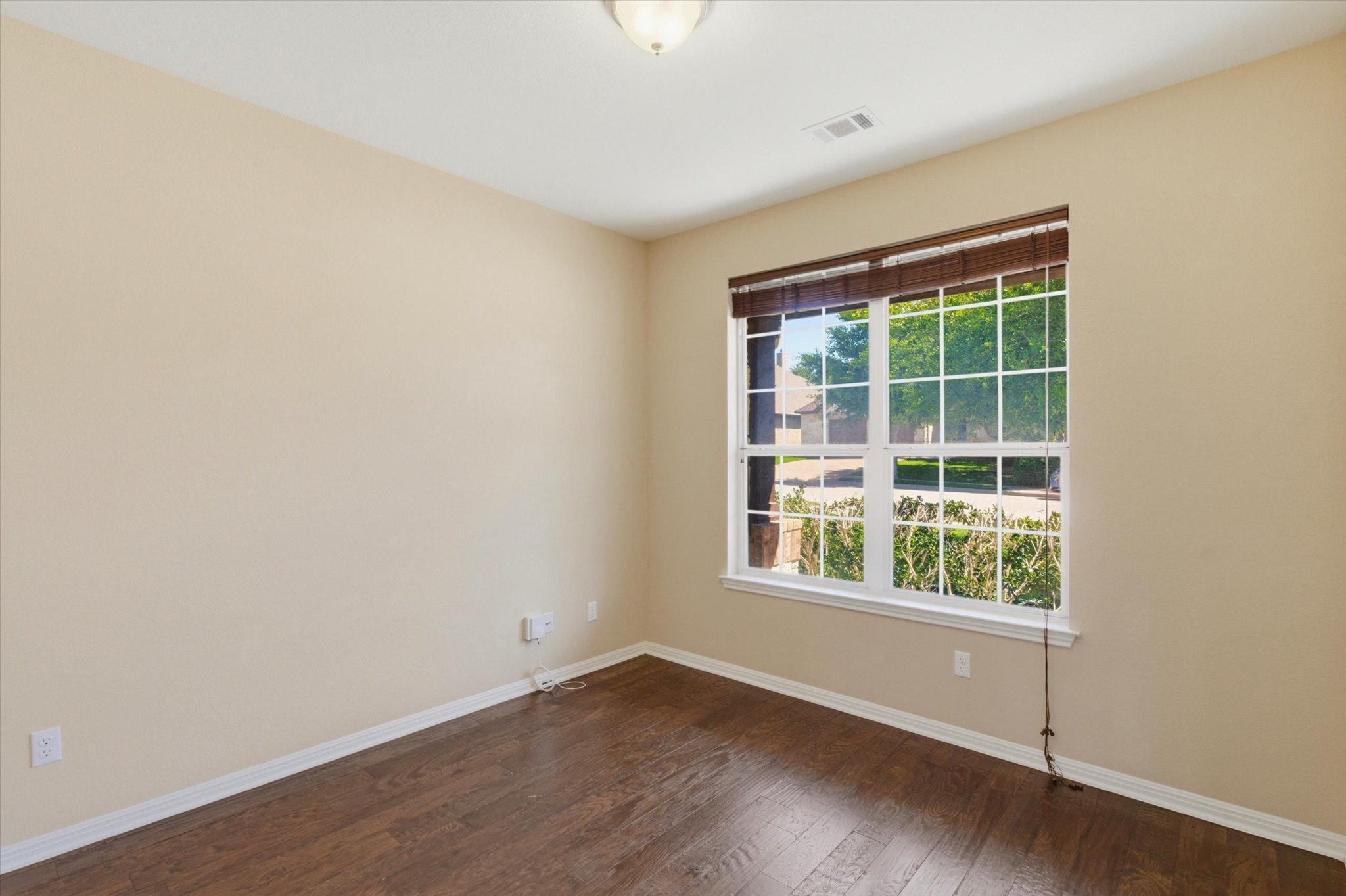 1511 Rimstone Drive Cedar Park, TX 78613 - Photo 7 of 39 Rich hardwood flooring complements sun-filled views through a large window, offering a serene personal space.