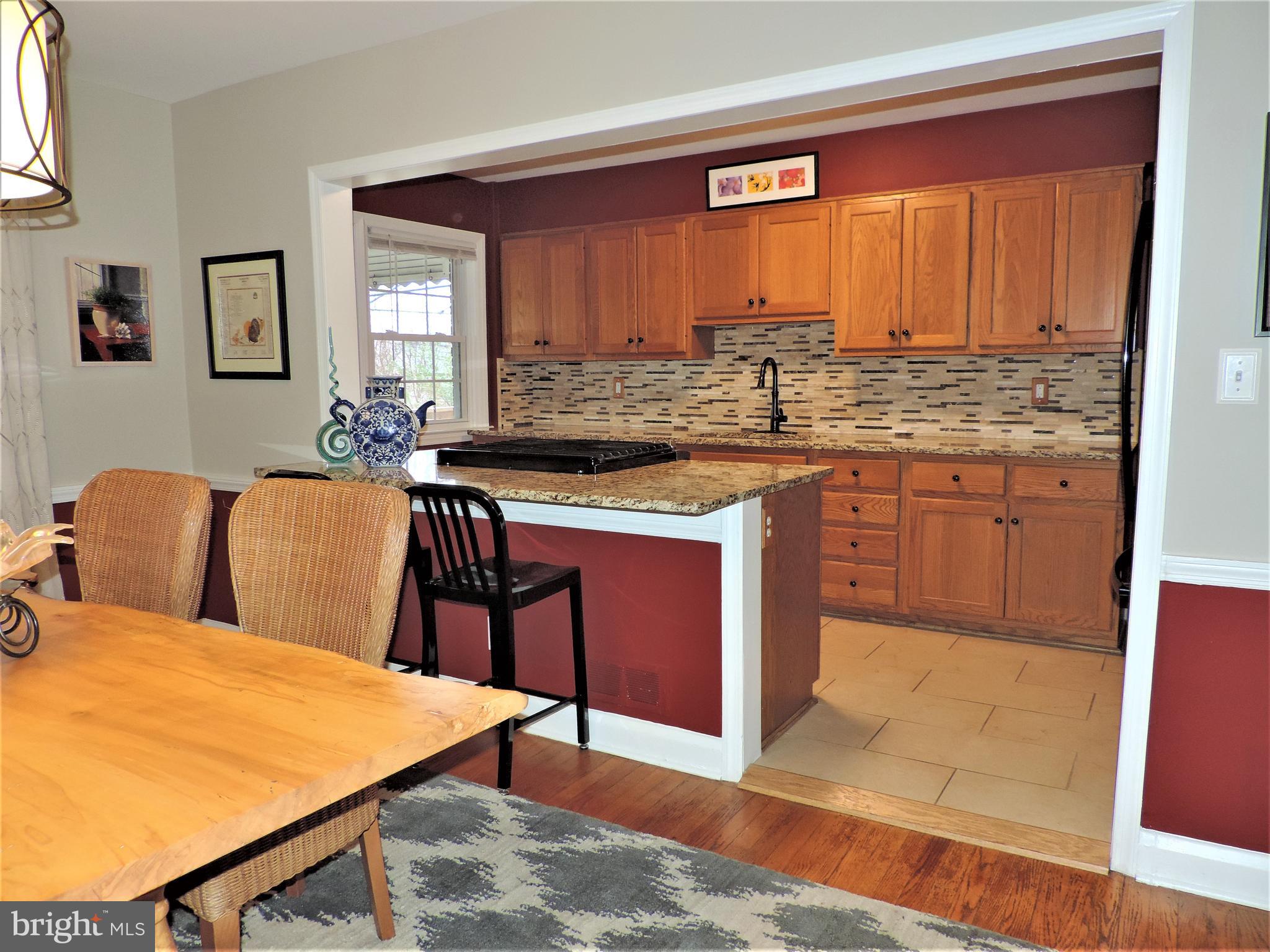 449 Whitfield Road Catonsville, MD 21228 - Photo 14 of 41 a kitchen with stainless steel appliances granite countertop wooden cabinets a sink and a stove