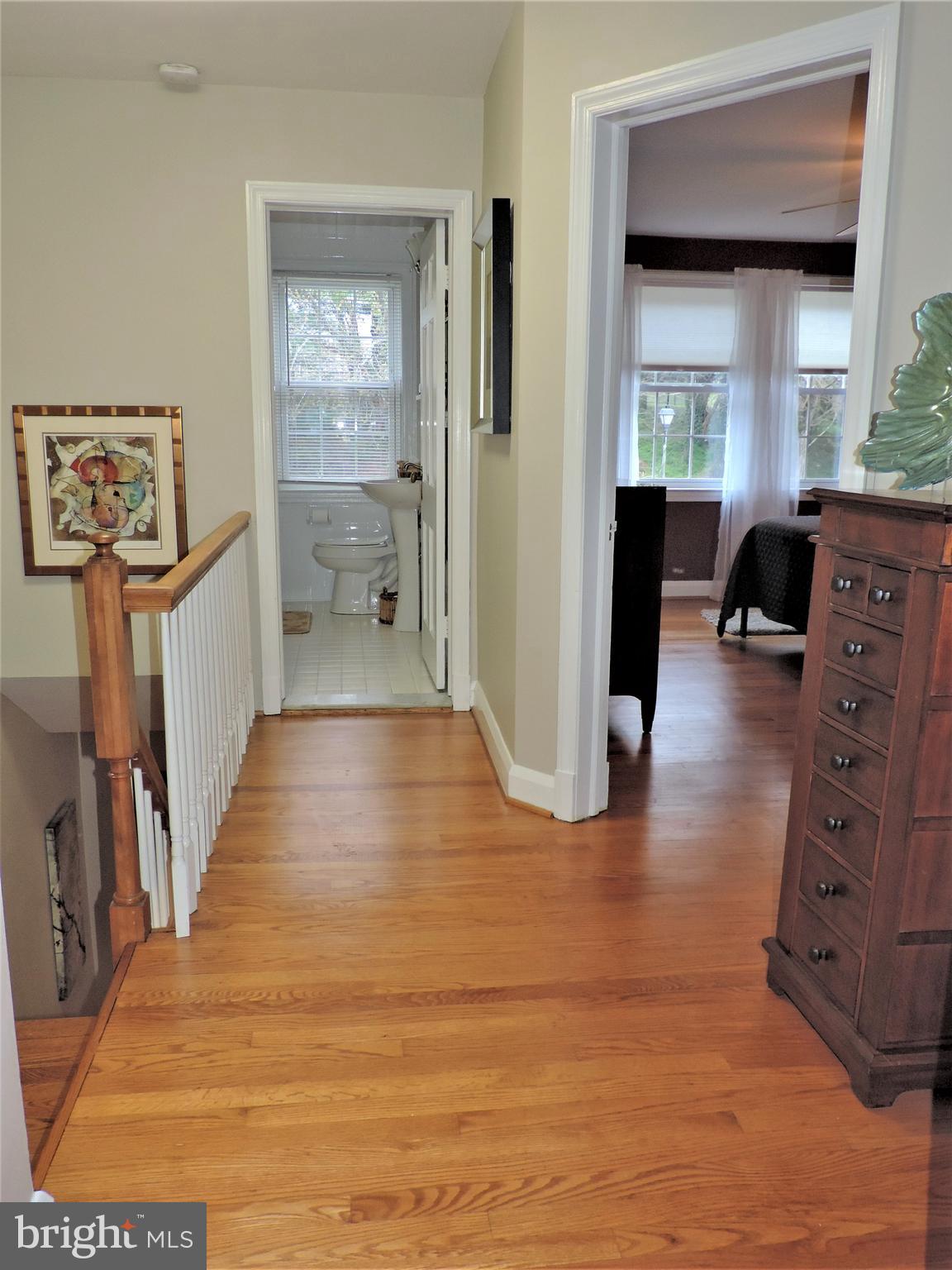 449 Whitfield Road Catonsville, MD 21228 - Photo 22 of 41 a view of a hallway to a livingroom with wooden floor and furniture
