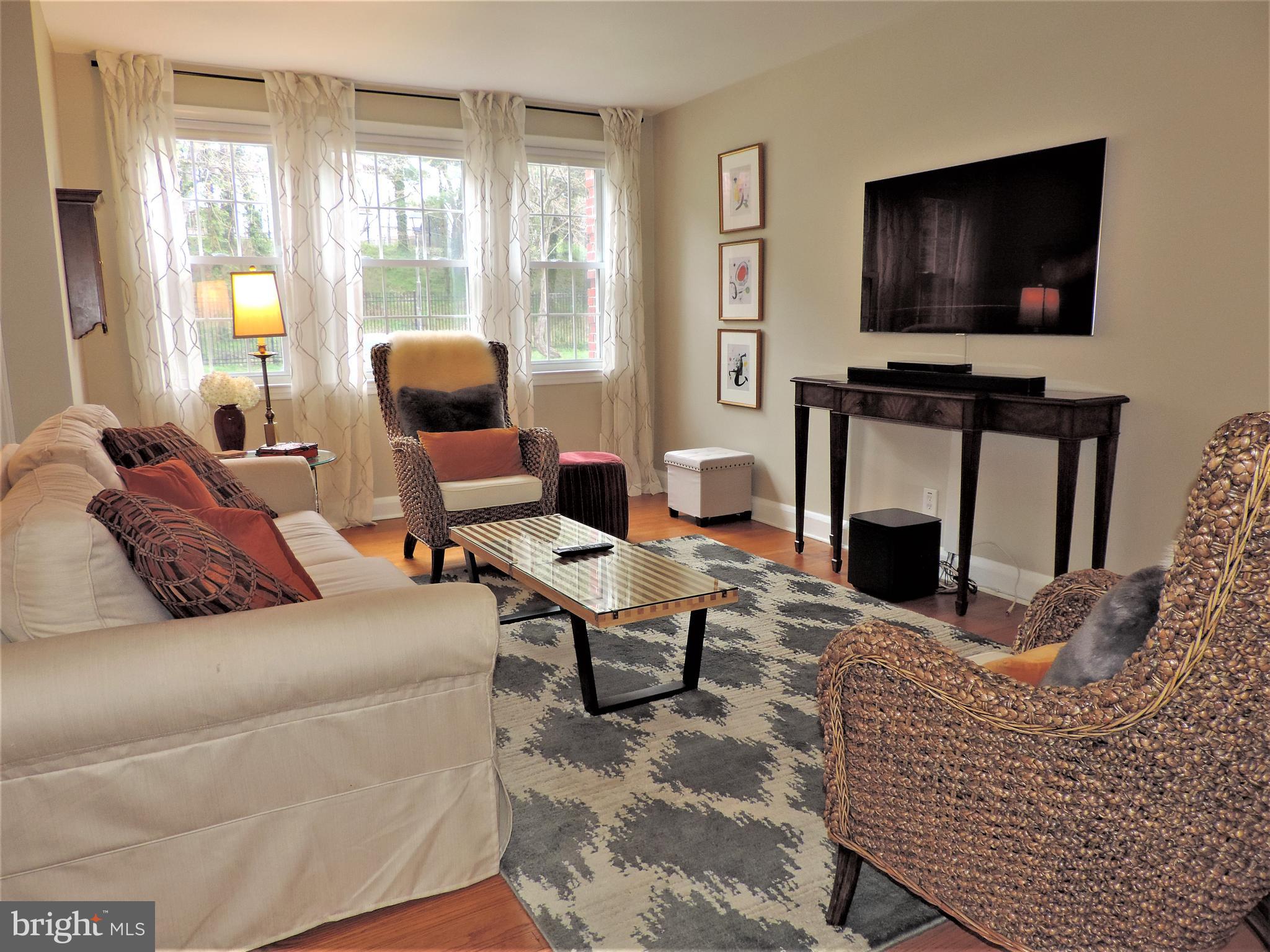 449 Whitfield Road Catonsville, MD 21228 - Photo 7 of 41 a living room with furniture a flat screen tv and a fireplace