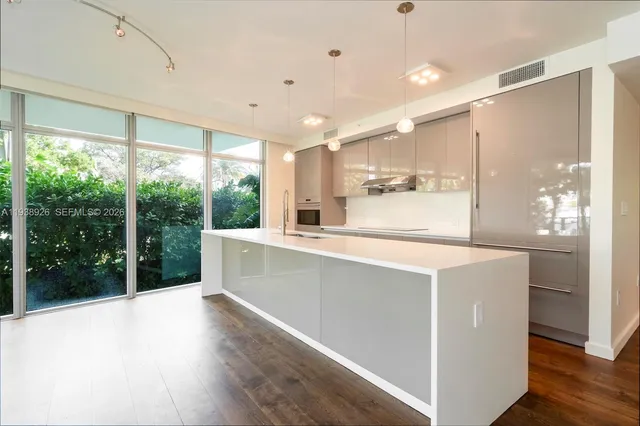 a kitchen with a sink cabinets and wooden floor