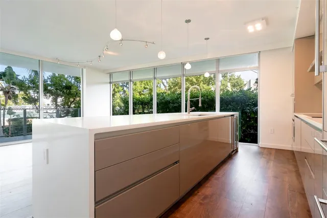 a view of hallway with wooden floor and large window