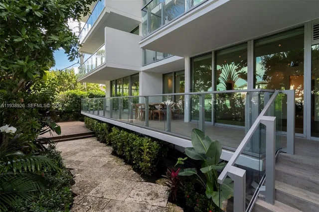 a view of a patio with chair and tables back yard of the house