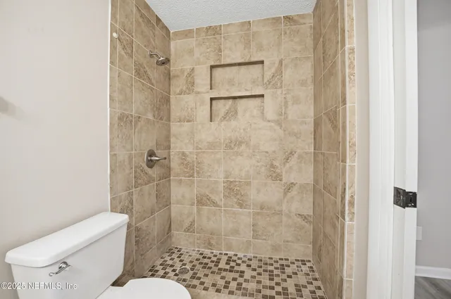 a bathroom with a toilet and shower