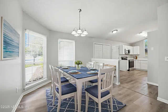 a view of a dining room with furniture and window