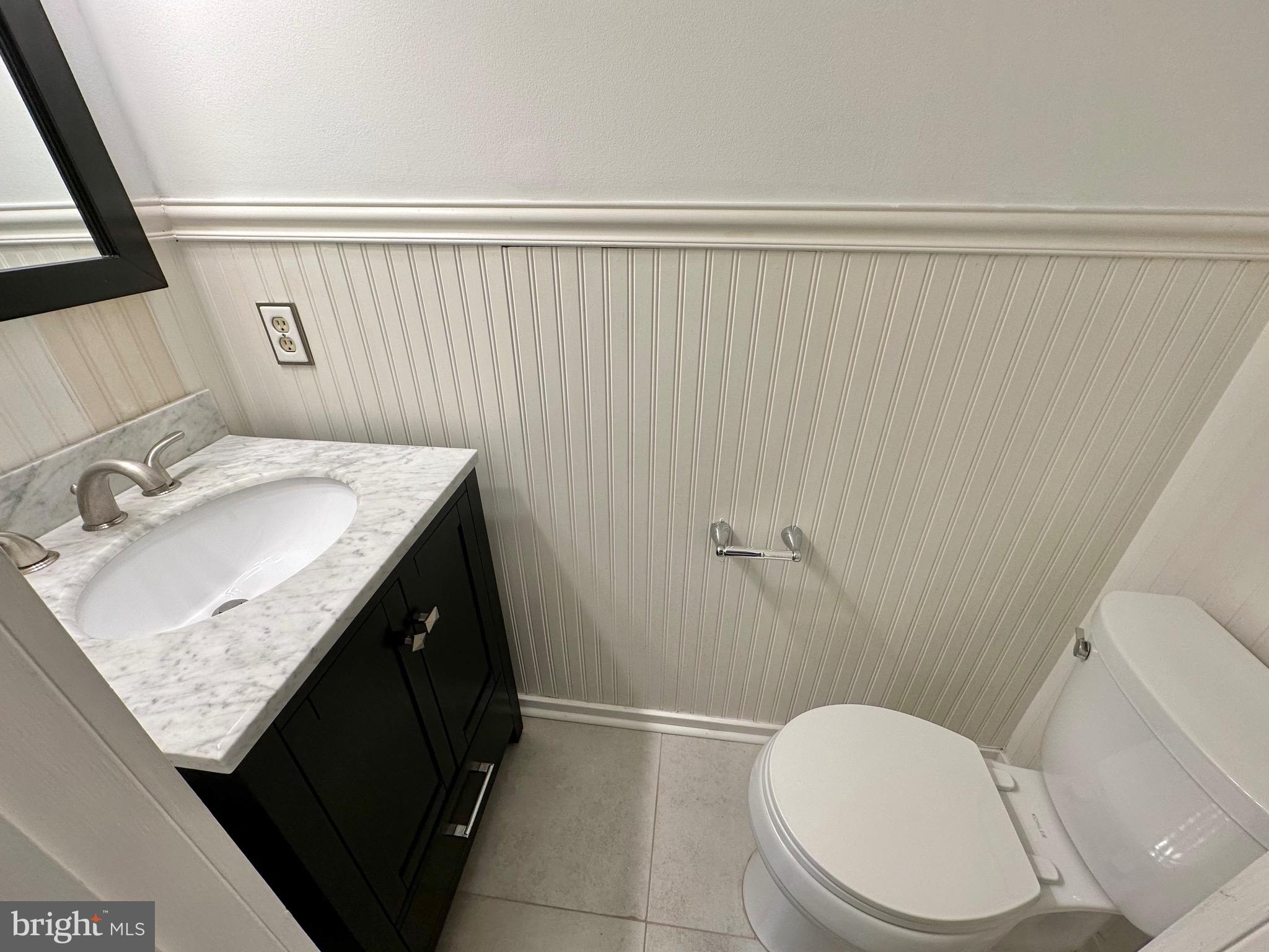 6001 Cloudy April Way Columbia, MD 21044 - Photo 12 of 12 a bathroom with a granite countertop sink toilet and a mirror