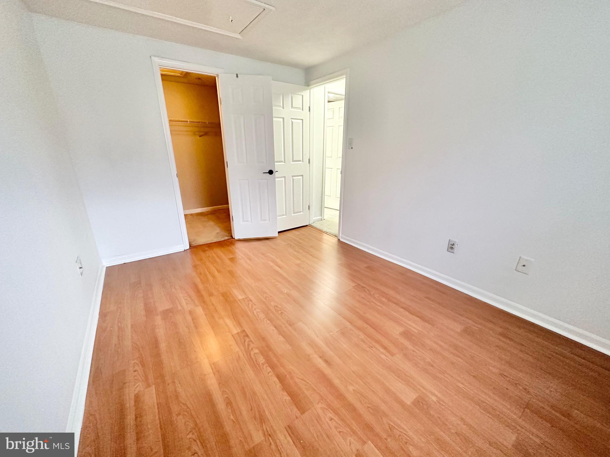 6001 Cloudy April Way Columbia, MD 21044 - Photo 5 of 12 a view of an empty room with wooden floor and a window