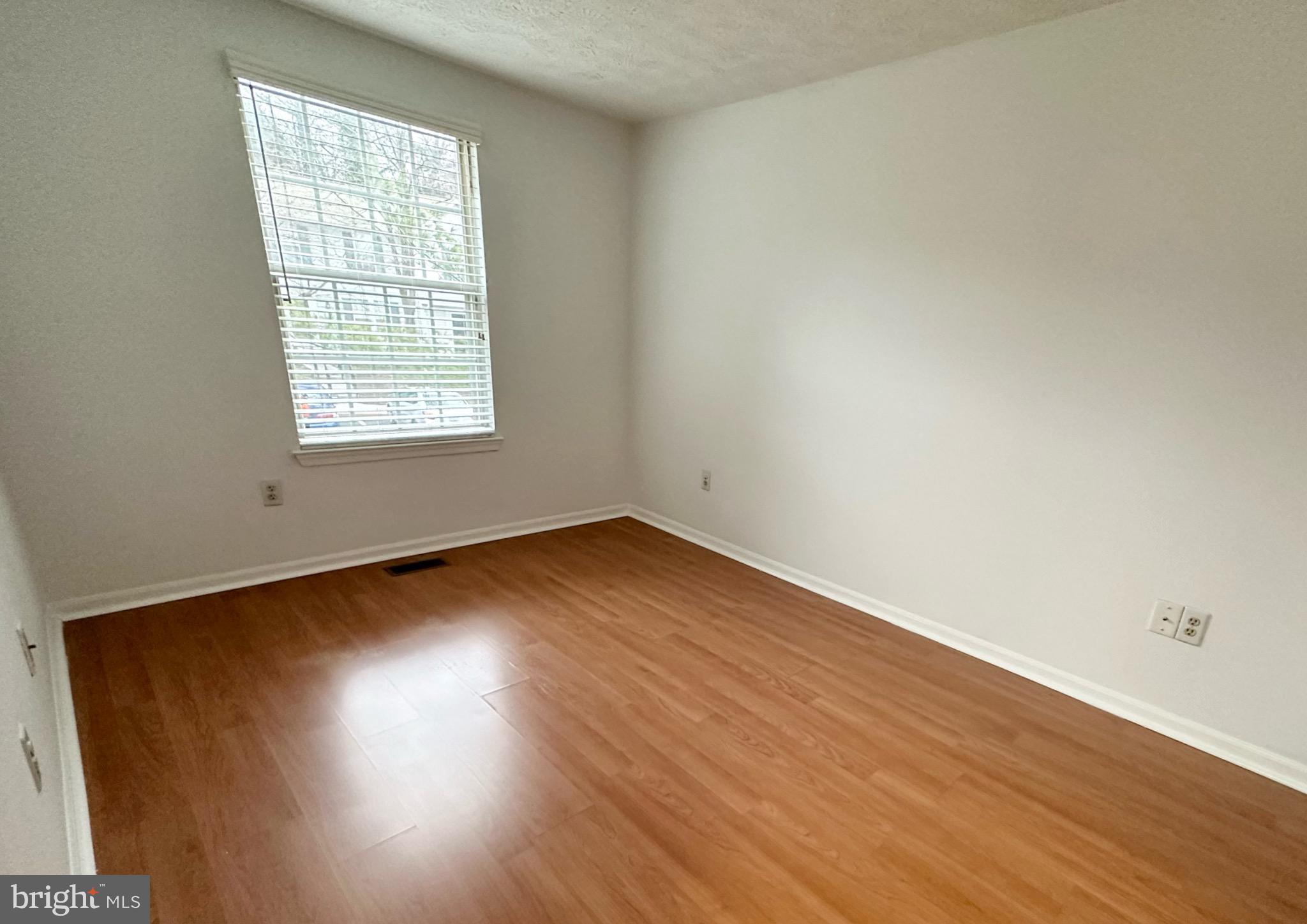 6001 Cloudy April Way Columbia, MD 21044 - Photo 6 of 12 an empty room with wooden floor and windows