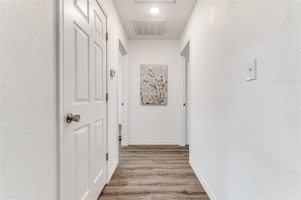 7659 Double Bridge Road Mabank, TX 75156 - Photo 11 of 22 Corridor with a textured wall and wood finished floors