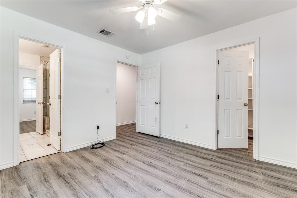 7659 Double Bridge Road Mabank, TX 75156 - Photo 13 of 22 Unfurnished bedroom with wood finished floors, connected bathroom, and ceiling fan