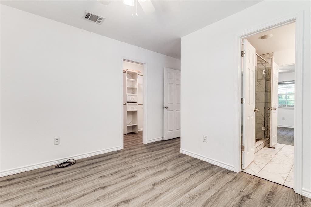 7659 Double Bridge Road Mabank, TX 75156 - Photo 15 of 22 Unfurnished bedroom featuring wood finished floors, a spacious closet, ensuite bathroom, and a ceiling fan