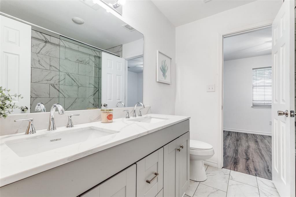 7659 Double Bridge Road Mabank, TX 75156 - Photo 17 of 22 Bathroom featuring marble finish floors, double vanity, and a shower