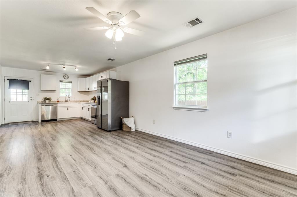 7659 Double Bridge Road Mabank, TX 75156 - Photo 3 of 22 Kitchen featuring appliances with stainless steel finishes, light wood-style floors, plenty of natural light, and light countertops