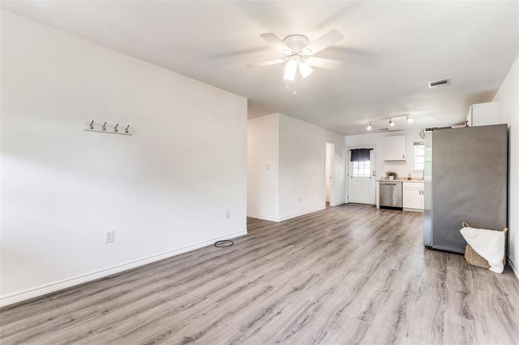 7659 Double Bridge Road Mabank, TX 75156 - Photo 4 of 22 Unfurnished living room with light wood finished floors and a ceiling fan