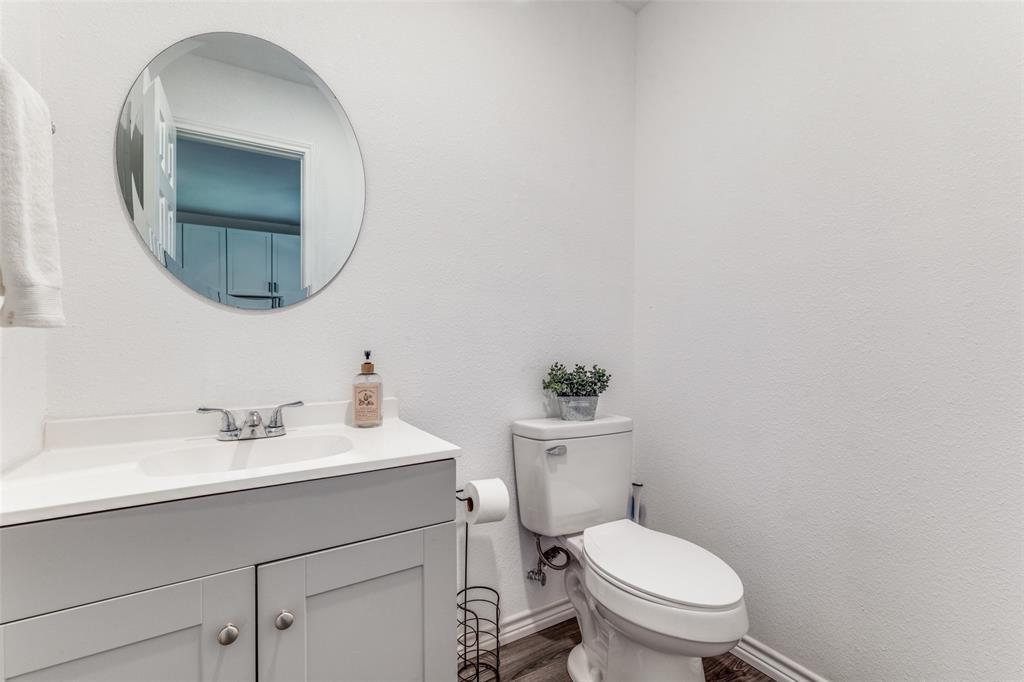 7659 Double Bridge Road Mabank, TX 75156 - Photo 10 of 22 Half bath with vanity, wood finished floors, and a textured wall