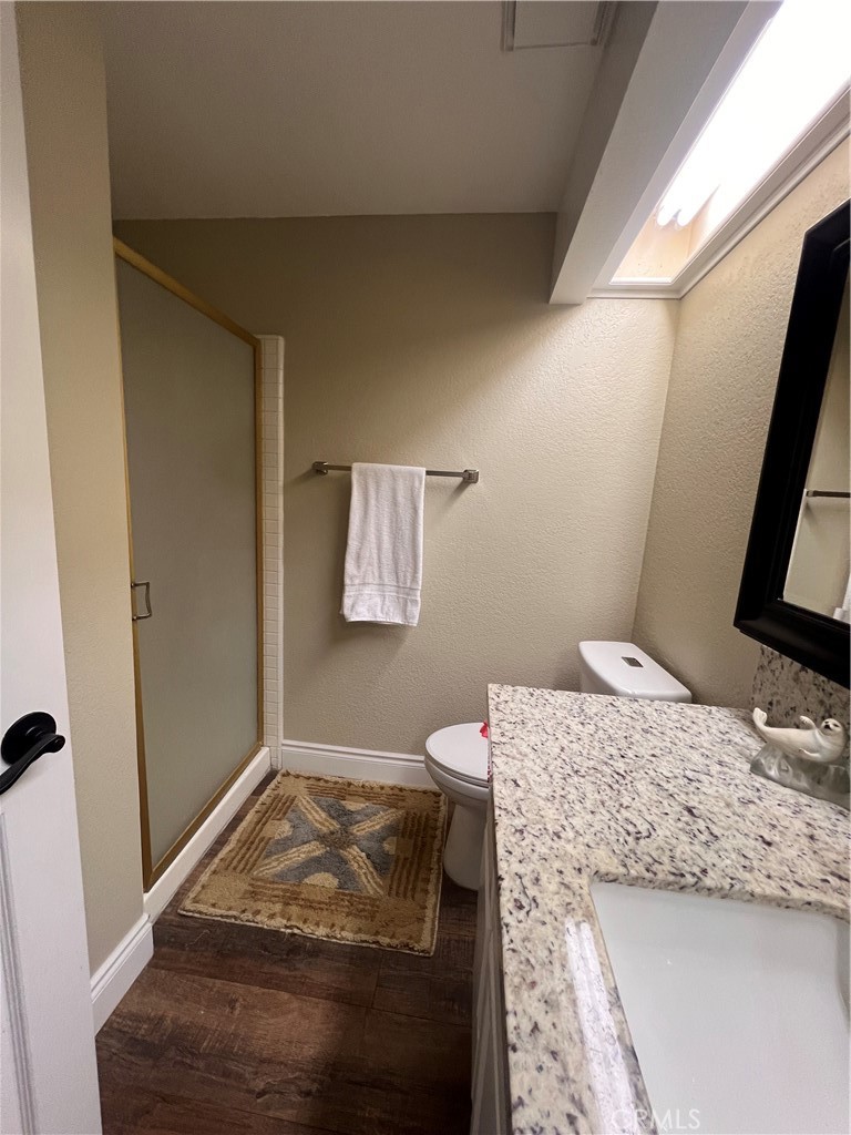 7158 Golden Vale Drive Riverside, CA 92506 - Photo 13 of 36 a bathroom with a granite countertop sink and a toilet