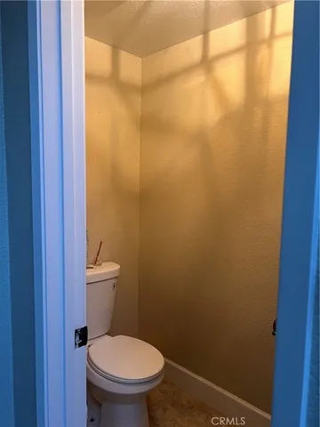 a white toilet sitting next to a shower