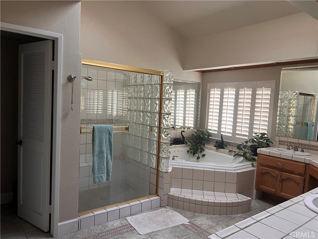 7158 Golden Vale Drive Riverside, CA 92506 - Photo 16 of 36 a bathroom with a sink a toilet a mirror and shower