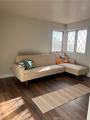 a sitting area with furniture and a rug