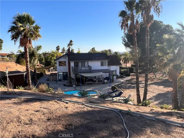 a backyard of a house with yard and outdoor seating