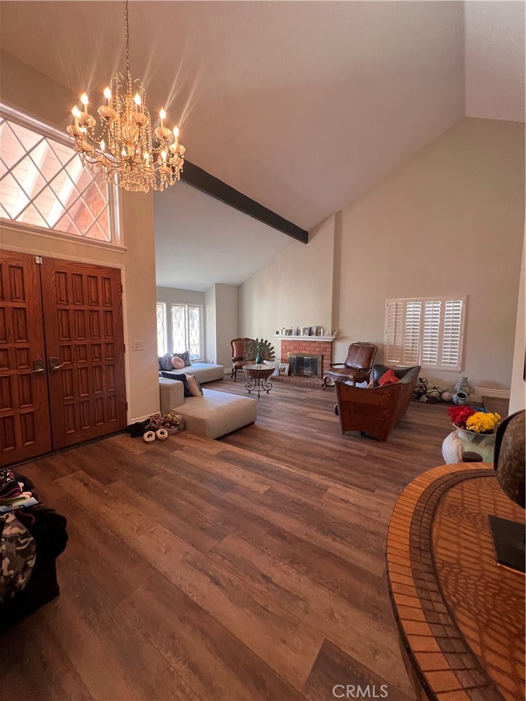 7158 Golden Vale Drive Riverside, CA 92506 - Photo 6 of 36 a living room with furniture a chandelier a rug and a window