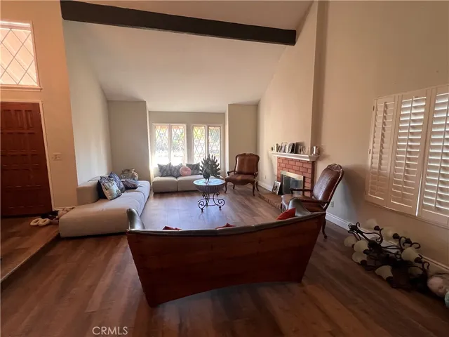 a living room with furniture window and wooden floor
