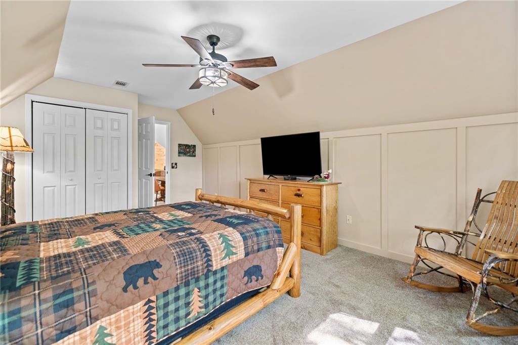 816 Alpine Drive Jasper, GA 30143 - Photo 23 of 51 a bedroom with a bed and a flat screen tv