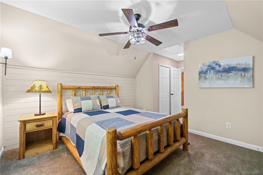 816 Alpine Drive Jasper, GA 30143 - Photo 24 of 51 a bedroom with a bed and a chandelier