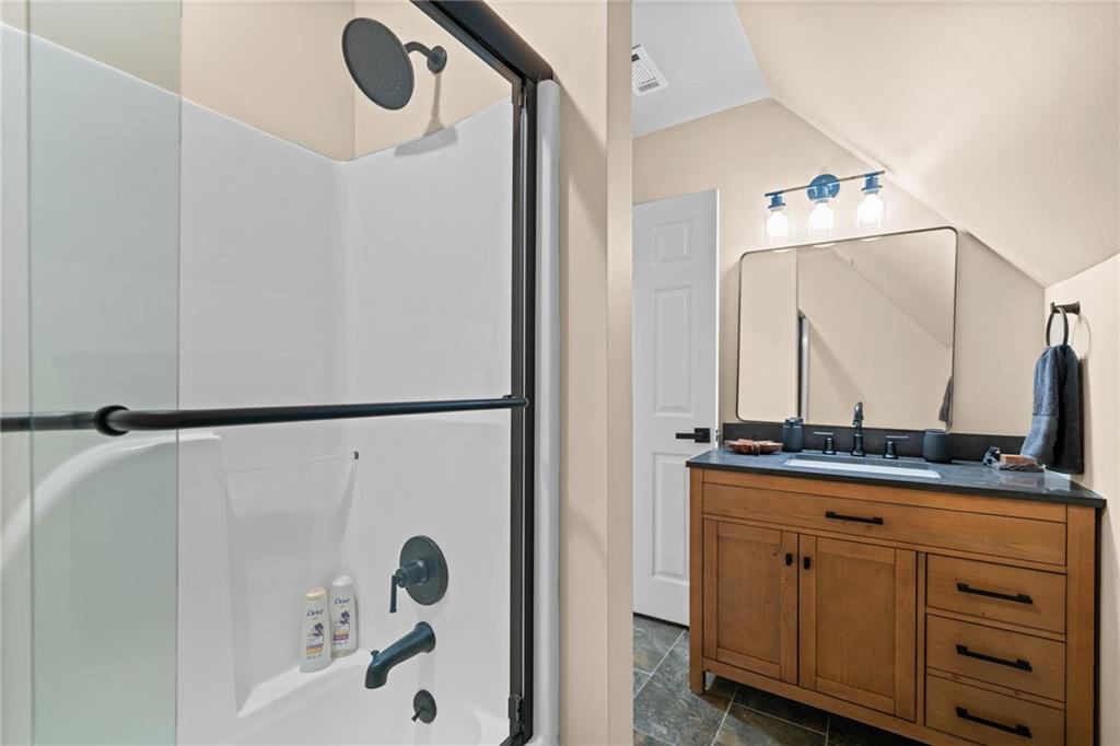 816 Alpine Drive Jasper, GA 30143 - Photo 25 of 51 a bathroom with a shower sink and mirror