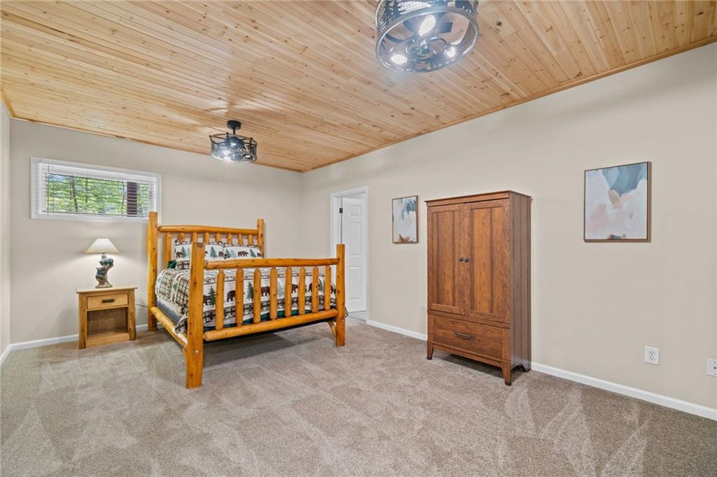 816 Alpine Drive Jasper, GA 30143 - Photo 27 of 51 a bedroom with furniture and a chandelier