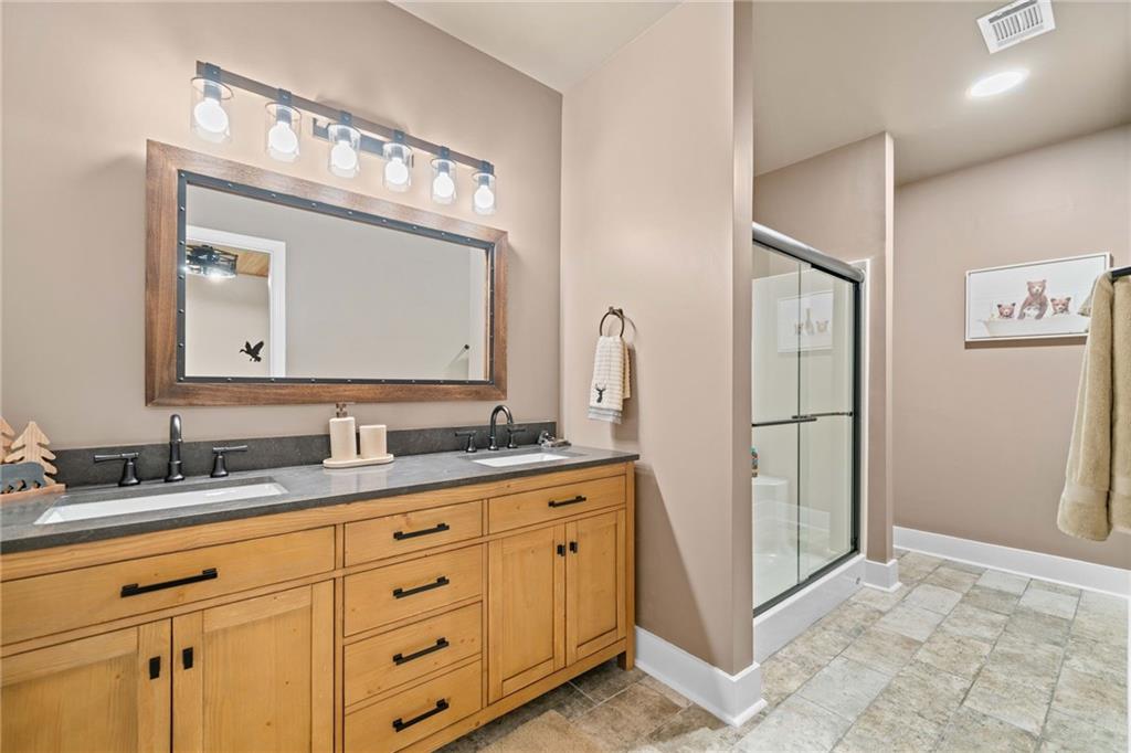 816 Alpine Drive Jasper, GA 30143 - Photo 28 of 51 a bathroom with a double vanity sink and mirror