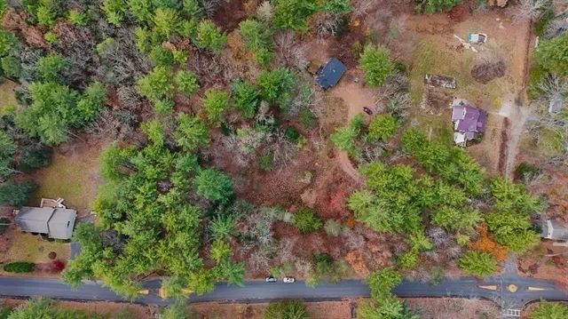 an aerial view of a house with a yard and lake view