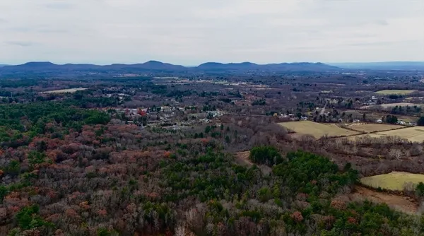 an aerial view of residential house and green field