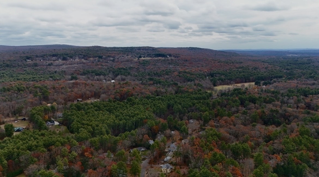 0 Heatherstone Road Amherst, MA 01002 - Photo 5 of 11 an aerial view of residential house with green space and mountain view in back