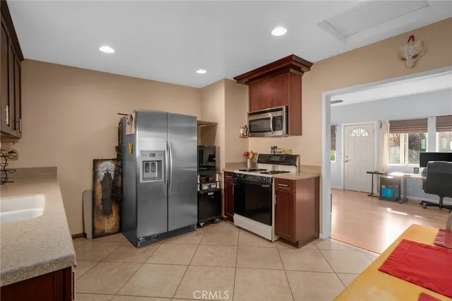 a kitchen with stainless steel appliances granite countertop a refrigerator and a stove