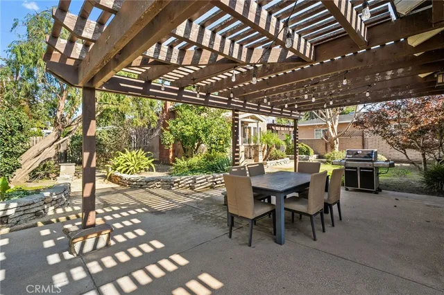 a view of a patio with table and chairs with wooden floor and fence
